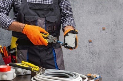 Lawrenceville, GA electrician preparing tools and wiring for a service call