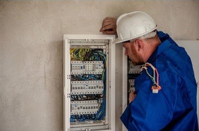 Licensed Lawrenceville, GA electrician working inside a residential electrical panel